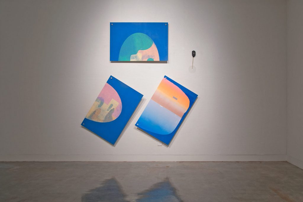 A gallery view with three wall paintings.