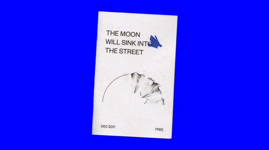 The front cover of a slender book against a blue background.