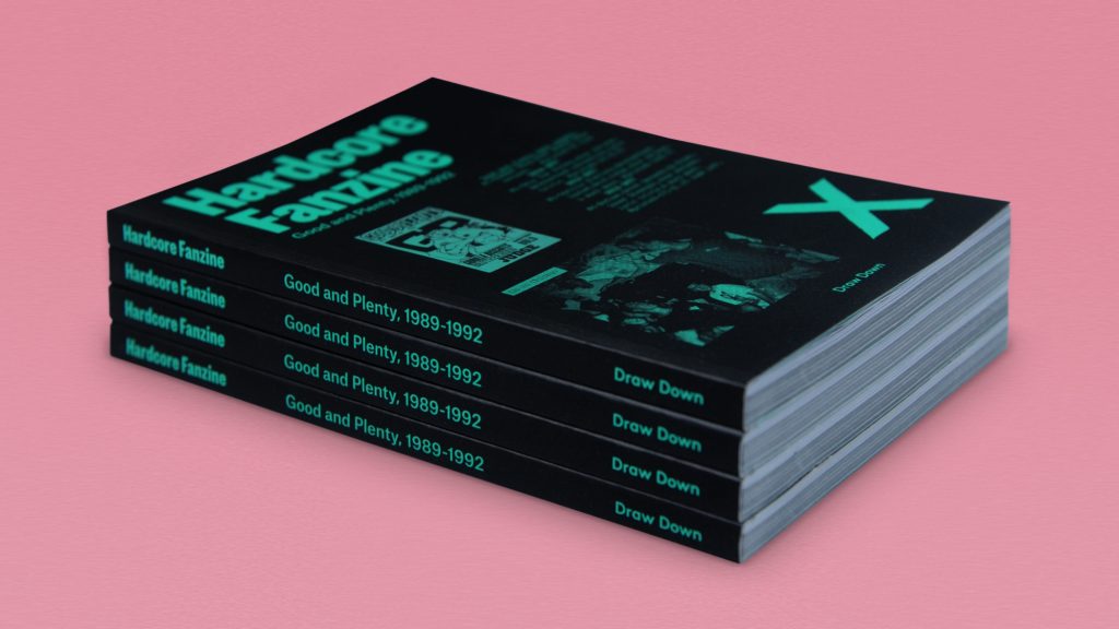 A stack of black books called "Hardcore Fanzines" on a pink background .