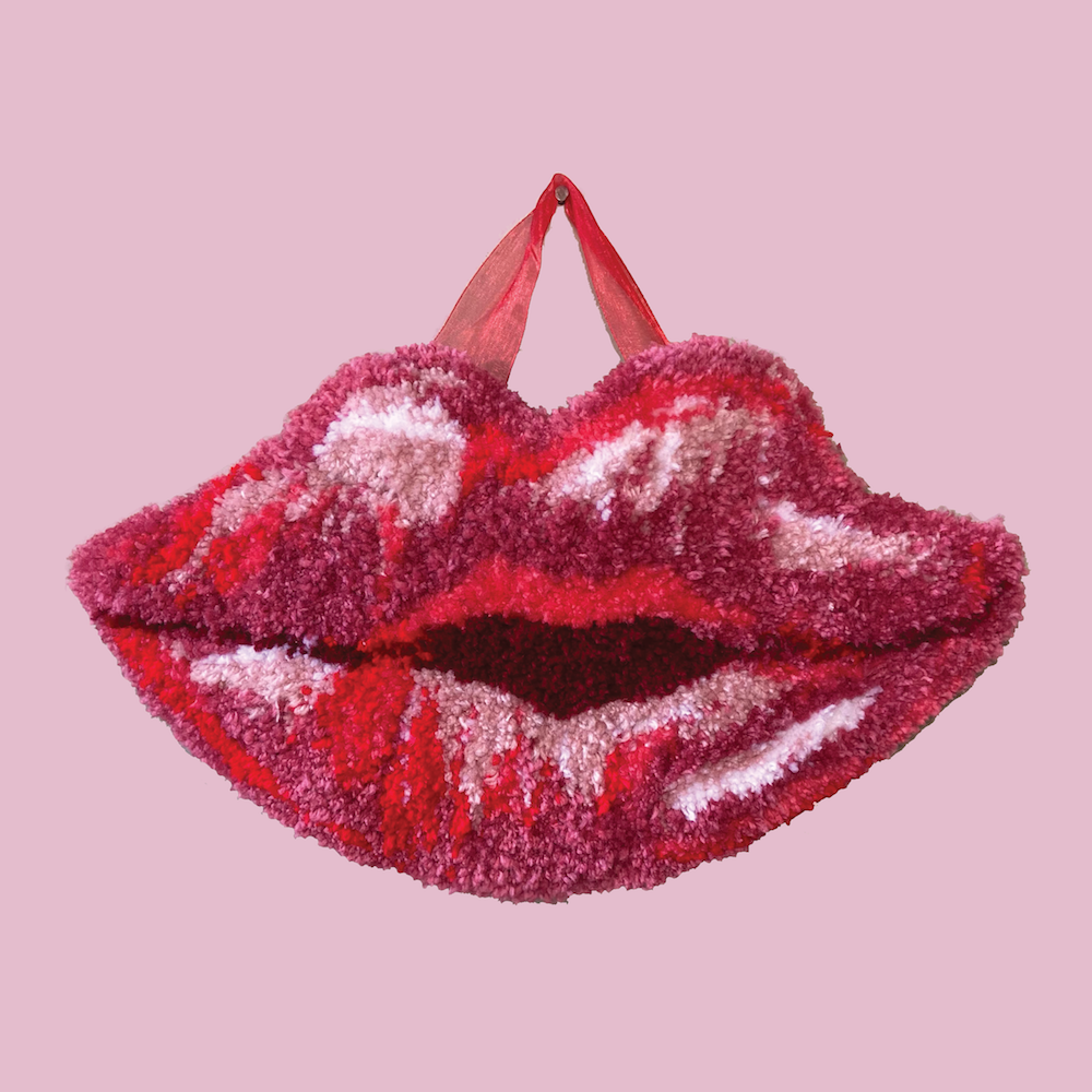 Tufted rug in the shape of lips