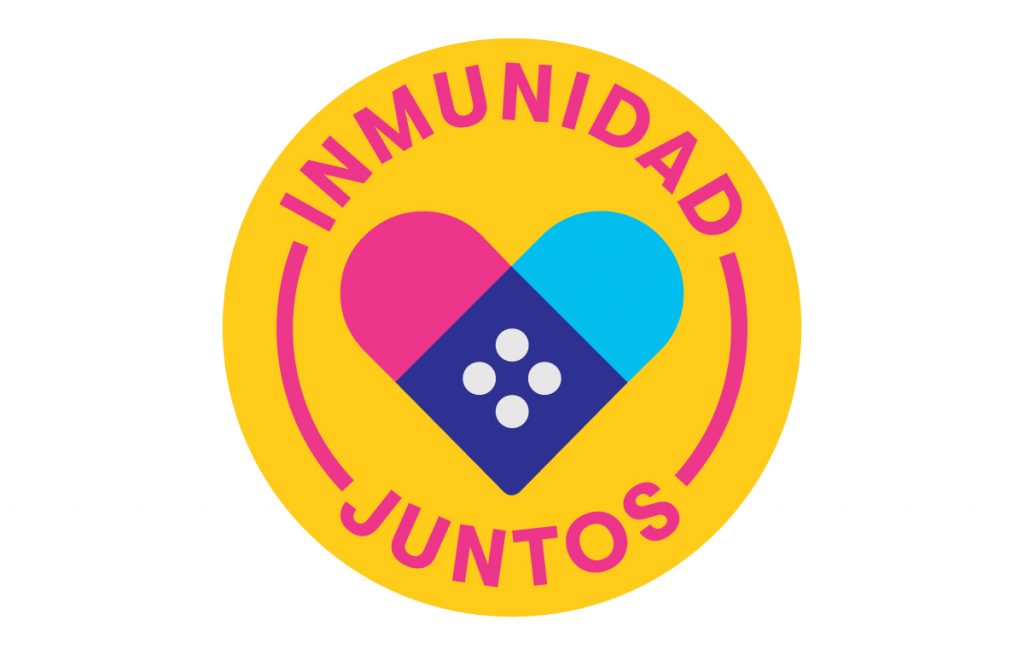 A yellow sticker with Spanish text around a symbol of two bandaids forming a heart.